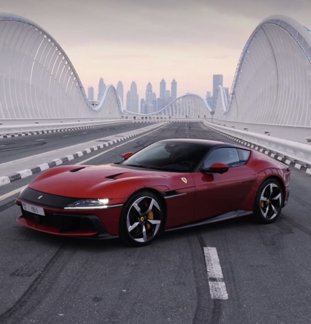 Red Ferrari 12Cilindri parked on a bridge in Dubai, available for rent from YAZ Car Rental